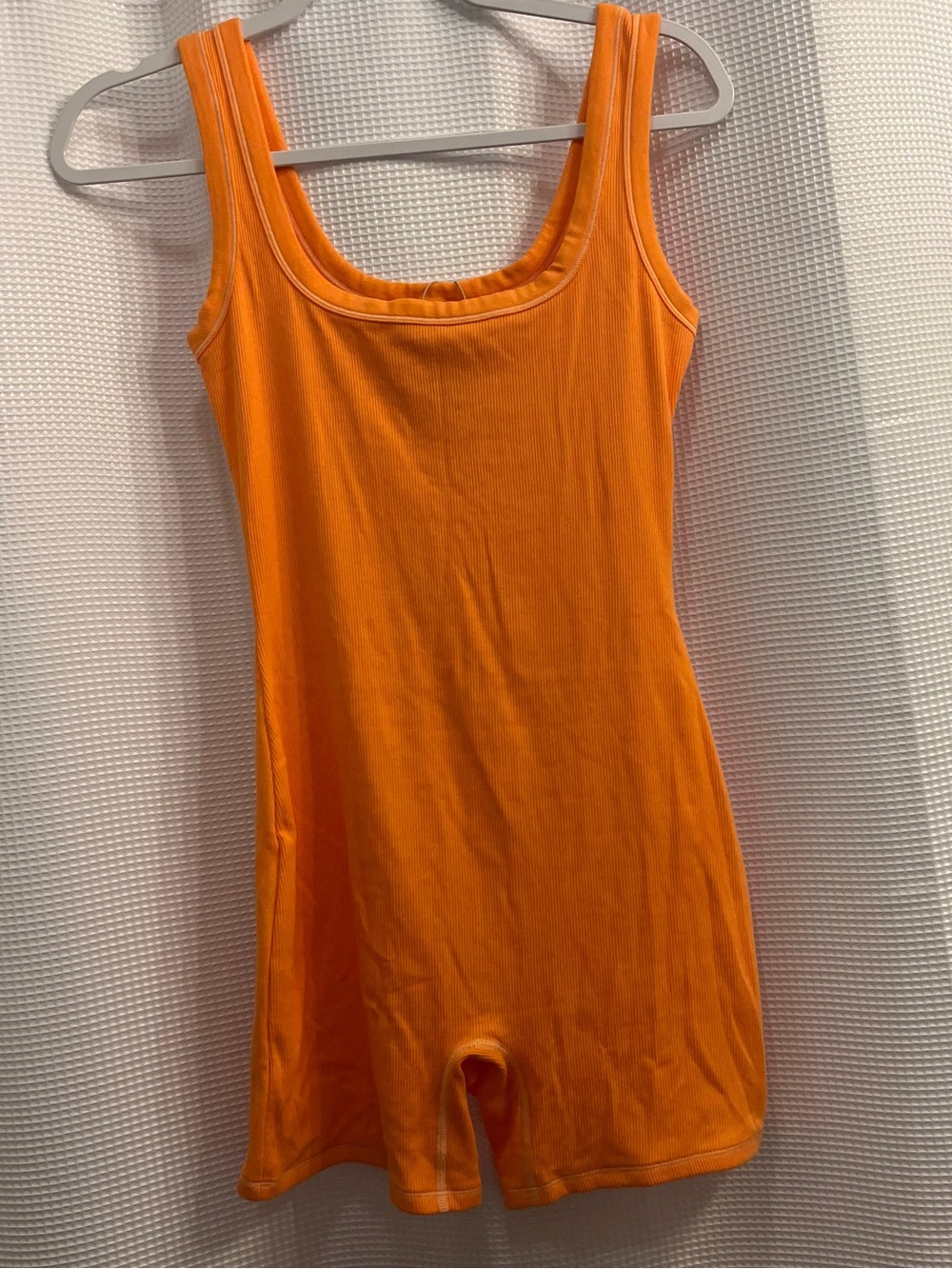 Skims cotton ribbed romper in apricot